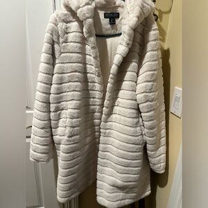Woman’s long furry coat with hood